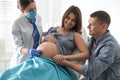 Doctor examining woman before giving child birth in maternity hospital Royalty Free Stock Photo