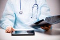 Is the doctor examining an x-ray, on the table in front of him is a tablet computer Royalty Free Stock Photo