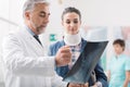 Doctor examining a young female patient`s x-ray Royalty Free Stock Photo