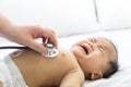 Doctor exams Asian newborn baby with stethoscope in the hospital Royalty Free Stock Photo