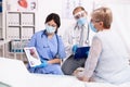 Doctor exmplaining heart disease to senior woman at hospital cardiology Royalty Free Stock Photo