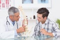 Doctor explaining anatomical spine to his patient Royalty Free Stock Photo