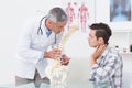 Doctor explaining anatomical spine to his patient Royalty Free Stock Photo