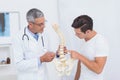 Doctor explaining anatomical spine to his patient Royalty Free Stock Photo