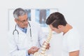 Doctor explaining anatomical spine to his patient Royalty Free Stock Photo