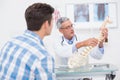 Doctor explaining anatomical spine to his patient Royalty Free Stock Photo