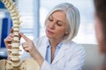 Doctor explaining anatomical spine to patient Royalty Free Stock Photo