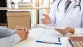 Doctor explaining and giving a consultation to a patient medical informations and diagnosis about the treatment for condition in Royalty Free Stock Photo