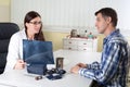 Doctor Explaining Lung X-ray Results to Middle Aged Patient in Consulting Room Royalty Free Stock Photo