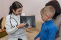 Doctor explaining and pointing on patient`s x-ray Royalty Free Stock Photo