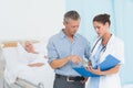 Doctor explaining report to female patient and husband Royalty Free Stock Photo