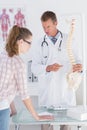 Doctor explaining a spine model to patient Royalty Free Stock Photo