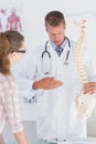 Doctor explaining the spine to his patient Royalty Free Stock Photo