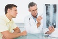 Doctor explaining spine xray to patient in office Royalty Free Stock Photo