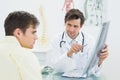 Doctor explaining spine xray to patient in office Royalty Free Stock Photo