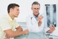 Doctor explaining spine xray to patient in office Royalty Free Stock Photo