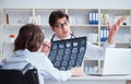 Doctor explaining to patient results of x-ray imaging Royalty Free Stock Photo