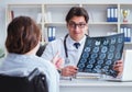 Doctor explaining to patient results of x-ray imaging Royalty Free Stock Photo