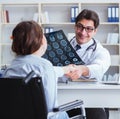 Doctor explaining to patient results of x-ray imaging Royalty Free Stock Photo