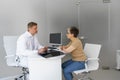 Doctor explaining x-ray result for sick female patient in hospital office. Healthcare concept Royalty Free Stock Photo