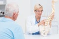 Doctor explaning anatomical spine to senior patient Royalty Free Stock Photo