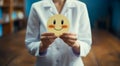 A doctor expresses emotions through happy and sad face paper for mental health assessment