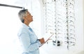 Doctor, eye care or mature woman with checklist in store for retail stock, inventory or eyewear choice. Vision