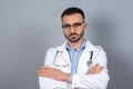 Doctor in eyeglasses standing with arms crossed Royalty Free Stock Photo