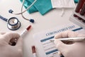 Doctor filling in coronavirus test form on the laboratory bench