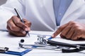 Doctor Filling Form Over The Desk Royalty Free Stock Photo