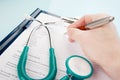 Doctor filling in medical questionnaire document Royalty Free Stock Photo