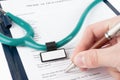 Doctor filling in medical questionnaire document Royalty Free Stock Photo