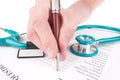 Doctor filling in medical questionnaire document Royalty Free Stock Photo