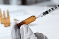 Doctor filling syringe with medication from pharmaceutical ampoule indoors, closeup Royalty Free Stock Photo