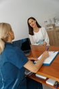 Doctor fills out the medical report form on medical care of patients during appointment Royalty Free Stock Photo