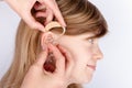 Doctor fitting a young girl with hearing aid Royalty Free Stock Photo