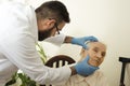 The doctor geriatrician during the test. Doctor examines changes in the skin of an old woman.