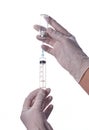 The doctor gets the vaccine into the syringe. Glass bottle in a technician`s hand