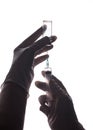 The doctor gets the vaccine into the syringe. Glass bottle in a technician`s hand