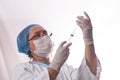 The doctor gets the vaccine into the syringe. Glass bottle in a technician`s hand