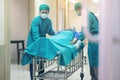 Doctor Getting their patient ready for the next procedure In the corridor, a medical team is pushing an emergency stretcher bed Royalty Free Stock Photo