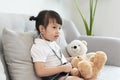 A doctor girl playing and cure bear at the pediatric Royalty Free Stock Photo