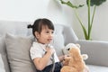 A doctor girl playing and cure bear at the pediatric Royalty Free Stock Photo