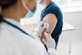 doctor gives an injection in the shoulder Patient in T-shirt Patient covid vaccination Royalty Free Stock Photo