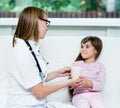 Doctor gives to drink to the sick child