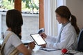 Doctor giving advice to her female patient about medication and treatment method. Royalty Free Stock Photo