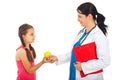 Doctor giving apple to girl Royalty Free Stock Photo