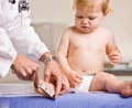 Doctor giving baby girl checkup in doctor office