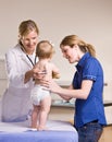 Doctor giving baby girl checkup in doctor office Royalty Free Stock Photo