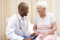 Doctor giving checkup to woman in exam room Royalty Free Stock Photo